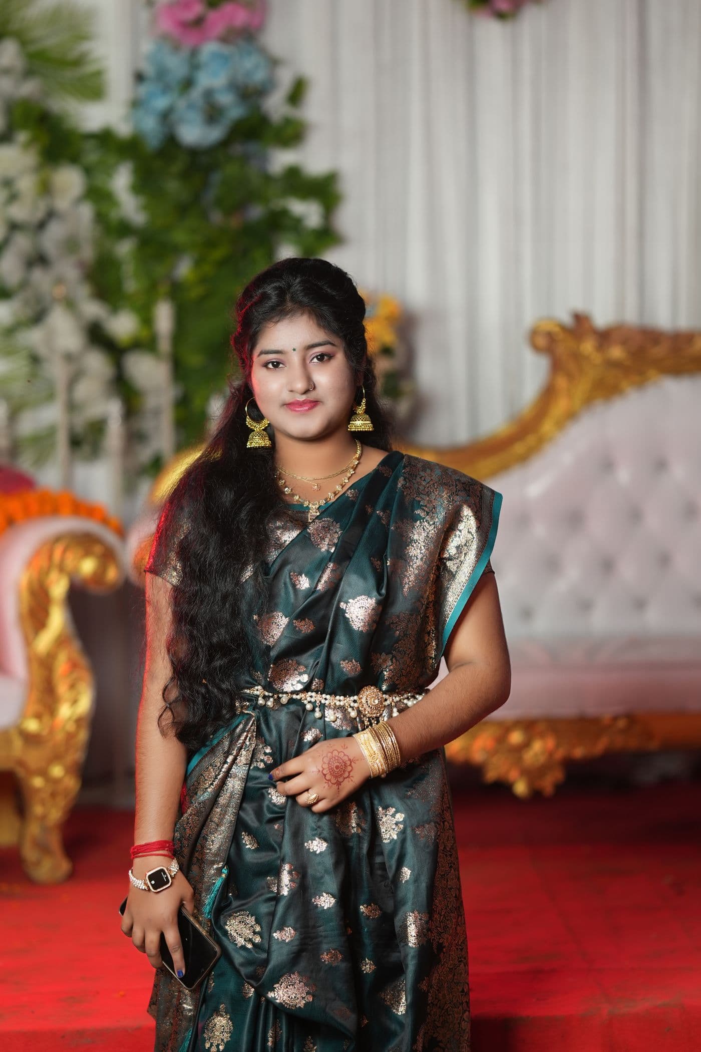 Woman in a dark embellished outfit in warm low light