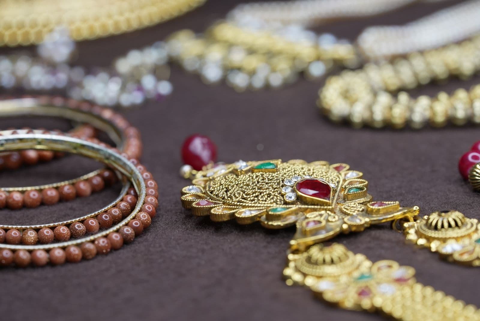 Traditional gold and beaded jewellery arranged in a display tray