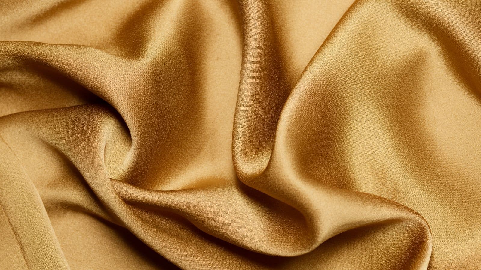 Folds of muted gold silk fabric