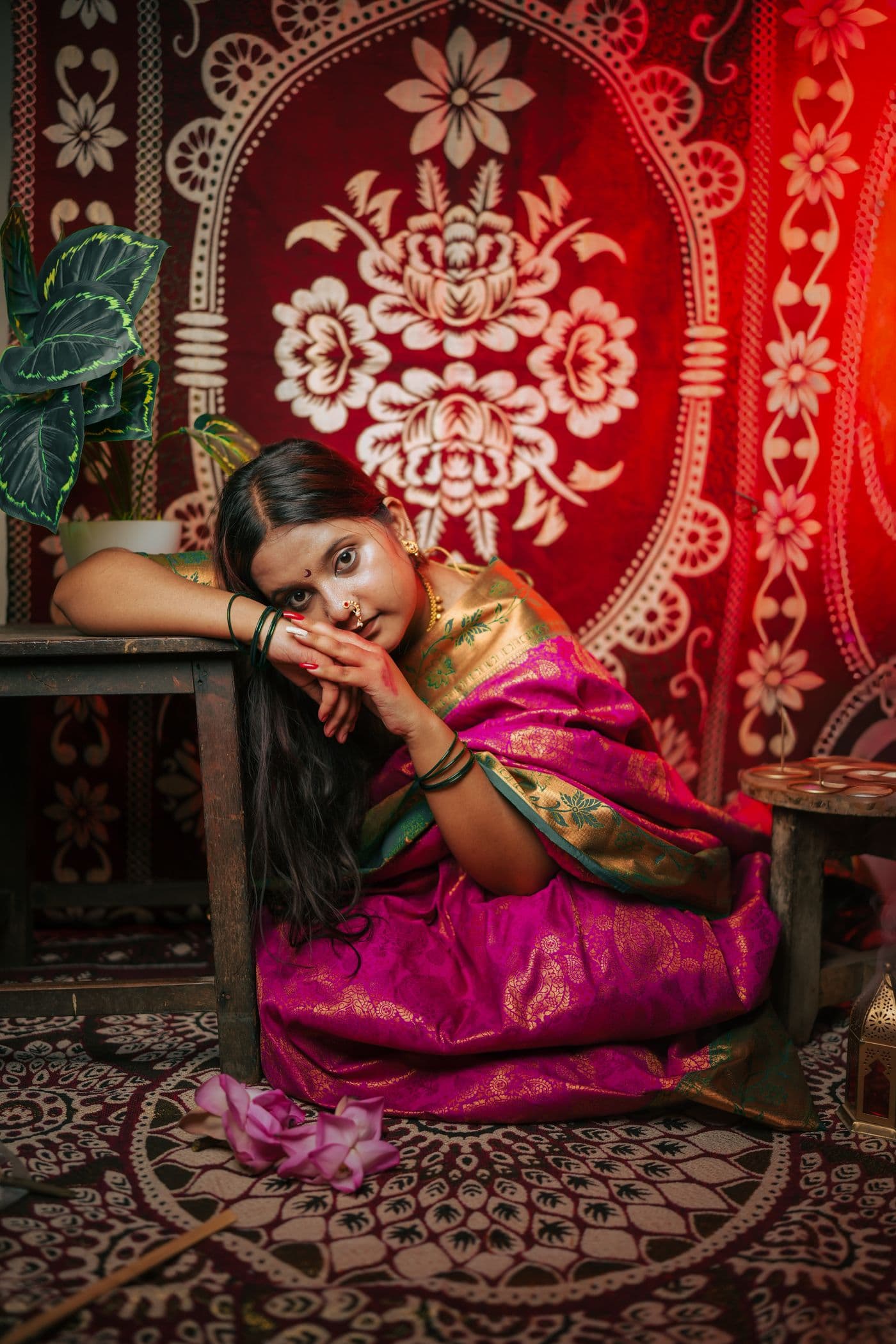 Woman reclining in a pink and gold embroidered celebration outfit