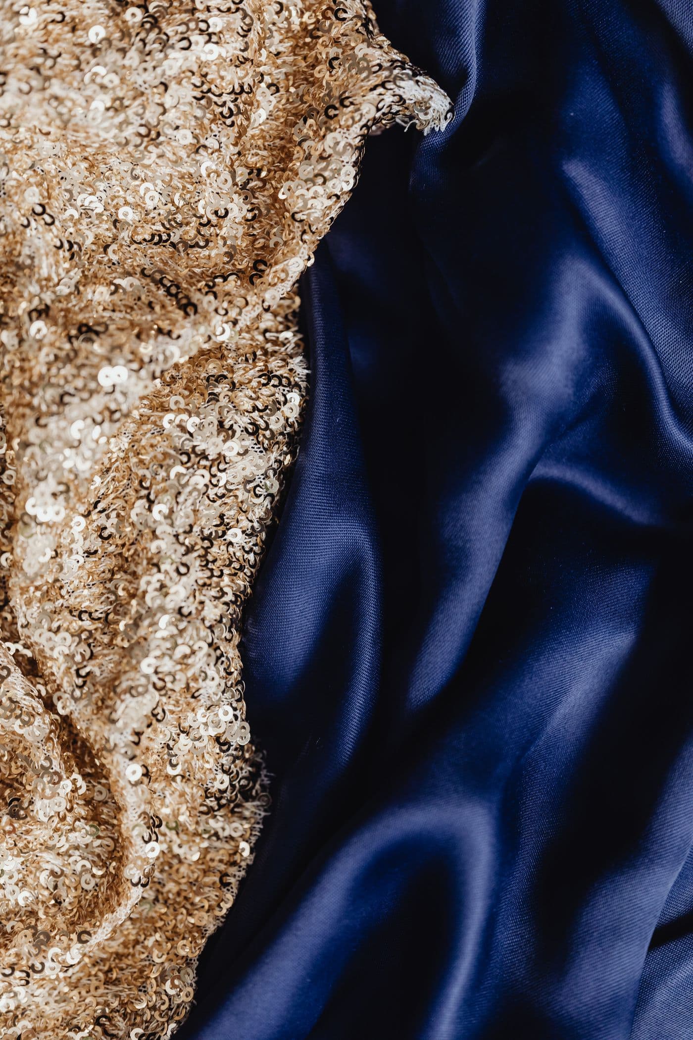 Gold sequins cascading over deep navy silk